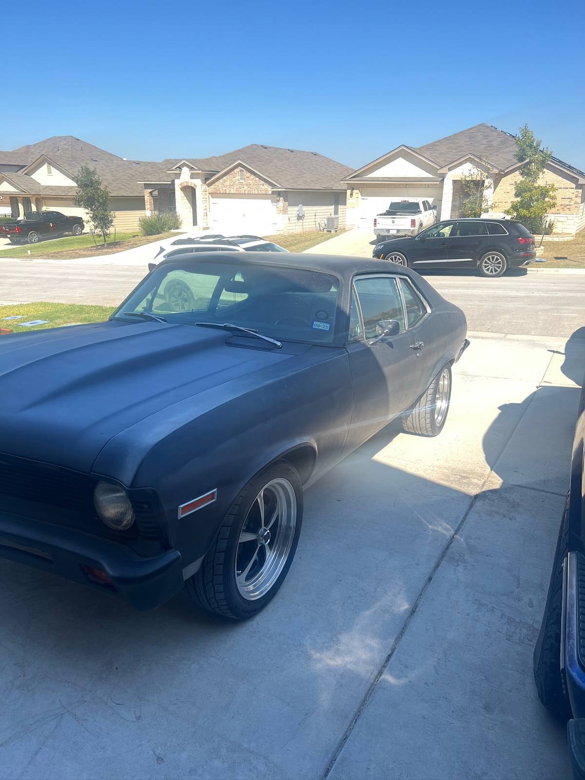 1971 Chevy Nova in primer on polished wheels
